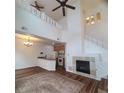 Open concept living room with fireplace, open to the kitchen, with stairs to the second level at 8802 E 24Th Pl # 101, Denver, CO 80238