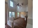 Bright, open living room with high ceilings, lots of windows, and modern ceiling fans at 8802 E 24Th Pl # 101, Denver, CO 80238