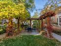 Secluded backyard features a pergola-covered dining area, perfect for outdoor entertaining at 8985 E 29Th Pl, Denver, CO 80238
