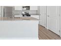 Bright kitchen featuring white cabinets, granite countertops, stainless steel appliances, and modern fixtures at 7307 Dolores Ave, Frederick, CO 80530