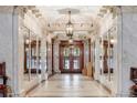 Impressive foyer featuring marble columns, mirrored walls, and ornate ceiling details at 836 E 17Th Ave # 1A, Denver, CO 80218