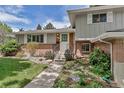 Charming front entrance of the home with brick accents and steps leading to the front door at 6211 S Garfield Dr, Centennial, CO 80121