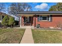 Charming brick home with walkway to the front porch at 2527 S Vine St, Denver, CO 80210