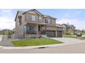 Attractive two-story home with a well-maintained lawn and a welcoming front porch at 2040 Rosette Pl, Castle Rock, CO 80104