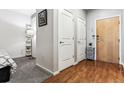 Condo entryway with hardwood floors next to a carpeted bedroom entrance at 2958 Syracuse St # 214, Denver, CO 80238