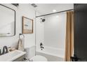 Modern bathroom with white subway tiles, bathtub, and updated fixtures at 1765 S Irving St, Denver, CO 80219