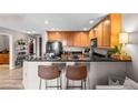 Open kitchen with granite counters, breakfast bar and stainless appliances for a chef's delight at 975 N Lincoln St # 12J, Denver, CO 80203