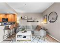Comfortable living room features a sectional sofa, accent rug, and shelving for decor at 975 N Lincoln St # 12J, Denver, CO 80203