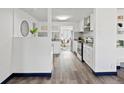 Bright kitchen featuring white cabinets, stainless steel appliances, and modern backsplash at 4842 Steele St, Denver, CO 80216