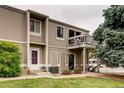 Two-story townhome with lawn and balcony, offering a cozy and inviting curb appeal at 7973 Chase Cir # 56, Arvada, CO 80003