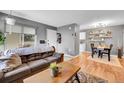 Cozy living room featuring a brown sofa, hardwood floors, and stylish decor at 7973 Chase Cir # 56, Arvada, CO 80003