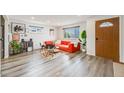 Bright living room featuring wood-look flooring, large windows, and stylish decor at 1308 W 102Nd Ave, Northglenn, CO 80260