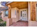 Front entry with wood columns and brick flooring at 1060 Cottonwood Cir, Golden, CO 80401