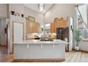 Spacious kitchen with light wood cabinets and granite island at 1060 Cottonwood Cir, Golden, CO 80401