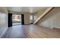 Light and bright living room featuring hardwood floors and a view of the backyard at 4266 W Pondview Dr, Littleton, CO 80123