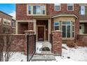 Inviting entryway with a brick facade and wrought iron gate, creating curb appeal at 9461 Elmhurst Ln # C, Highlands Ranch, CO 80129