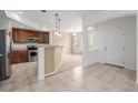Spacious kitchen with tile floors, wooden cabinets, and modern stainless steel appliances at 9461 Elmhurst Ln # C, Highlands Ranch, CO 80129