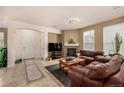 Comfortable living room with fireplace, tile floors, and lots of natural light at 9461 Elmhurst Ln # C, Highlands Ranch, CO 80129