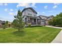 Well-maintained gray home showcases a lush green lawn with mature landscaping, enhancing curb appeal at 8182 Grady Cir, Castle Rock, CO 80108