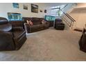 Spacious living room featuring comfortable seating, neutral carpet, and bright aquarium, perfect for relaxation at 7925 W Layton Ave # 322, Littleton, CO 80123