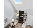 Bright living room with a skylight, sleek fireplace, built-in shelves, and comfortable seating at 2862 S Vaughn Way, Aurora, CO 80014