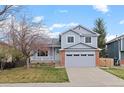 Charming two-story home with a blue exterior, front porch, well-manicured lawn, and an attached two-car garage at 11402 Benton Ct, Westminster, CO 80020