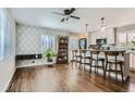 Open-concept living space with hardwood floors and modern kitchen features at 1171 Syracuse St, Denver, CO 80220