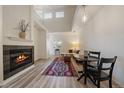 Bright living room featuring a fireplace, wood-look flooring, and dining area at 5465 Zephyr St # 201, Arvada, CO 80002