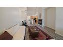 Inviting living room featuring a fireplace, wood-look flooring, and dining area at 5465 Zephyr St # 201, Arvada, CO 80002