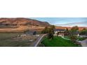 Picturesque estate featuring a modern home, outbuilding, and mountain backdrop at 17326 W 57Th Ave, Golden, CO 80403