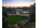 Expansive property with manicured lawn, solar panels, and tranquil wooded surroundings at 17326 W 57Th Ave, Golden, CO 80403