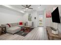 Bright living room with modern flooring, a cozy gray couch, and plenty of natural light at 24257 E 41St Ave, Aurora, CO 80019