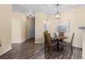 Dining room with hardwood floors and modern lighting fixtures at 7459 S Alkire St # 202, Littleton, CO 80127