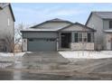 Charming single-Gathering home featuring stone accents, a gray two-car garage, and a beautifully landscaped yard at 1947 S Coolidge Way, Aurora, CO 80018