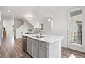 Lovely kitchen island featuring a stainless dishwasher and sink and a door that leads outside at 2140 Santini Trl # F, Littleton, CO 80129