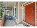 Welcoming front porch with brick accents, gray siding, and a 'Home Sweet Home' doormat at 2855 Rock Creek Cir # 191, Superior, CO 80027