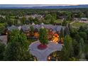 Panoramic aerial view of grand estate with circular driveway, lush landscaping and mature trees at 4030 E Forbes Ct, Greenwood Village, CO 80121