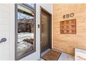 Townhome's front entrance with brick facade and decorative tile at 680 Crescent Ln, Lakewood, CO 80214