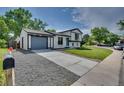 Exterior view showing a two-story house with a long driveway and a well-maintained front lawn at 9605 Carr St, Broomfield, CO 80021