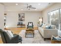 Inviting living room with hardwood floors, a ceiling fan, and bright, natural light at 4470 W Lakeridge Rd, Denver, CO 80219