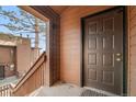 Private entrance featuring a staircase, balcony, and a secure front door at 540 S Forest St # 6-203, Denver, CO 80246
