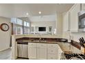 Modern kitchen open to the living space features stainless appliances and plenty of natural light at 21541 Unbridled Ave, Parker, CO 80138
