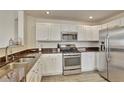 Well-equipped kitchen with stainless steel appliances, light cabinets, and stylish countertops at 21541 Unbridled Ave, Parker, CO 80138