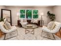Bright living room with large windows, designer furniture, and stylish decor at 6572 E Dakota Ave, Denver, CO 80224
