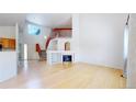 Bright living room with fireplace, soaring ceilings, and an open staircase with red accents at 2314 Flagstaff Dr, Longmont, CO 80504
