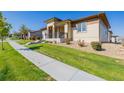 Well-maintained home with a walkway and manicured lawn at 10761 N Montane Dr, Broomfield, CO 80021