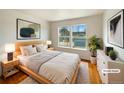 Bright, virtually staged primary bedroom featuring natural wood furniture and ample natural light from large window at 9486 E 107Th Ave, Commerce City, CO 80640