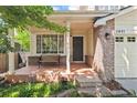 Inviting front porch with seating, stone steps, and well-maintained landscaping at 1441 Cherry Pl, Erie, CO 80516