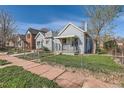 Quaint home with a fenced yard and a welcoming front porch, nestled in a residential neighborhood at 339 Delaware St, Denver, CO 80223