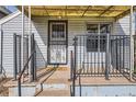 Inviting front porch with decorative railings and a sunny yellow awning, creating a cozy entrance at 339 Delaware St, Denver, CO 80223